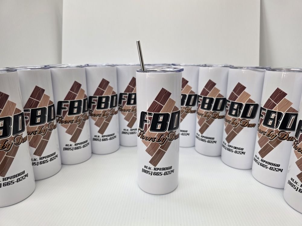 A row of white steel tumblers printed with a wood-floor company logo, license number and phone, one with a straw in front.